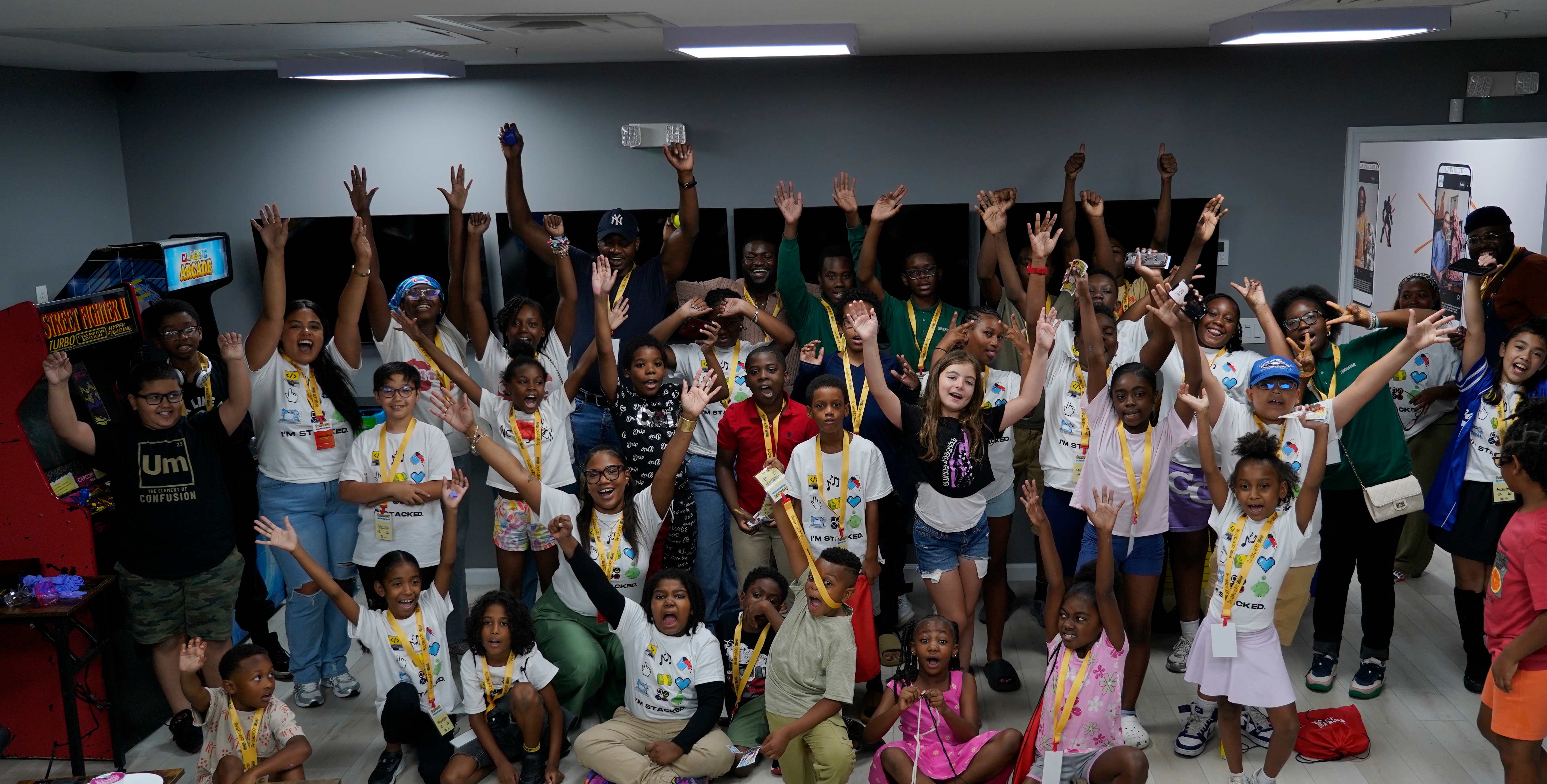The StackCon 2025 class cheering with their arms raised